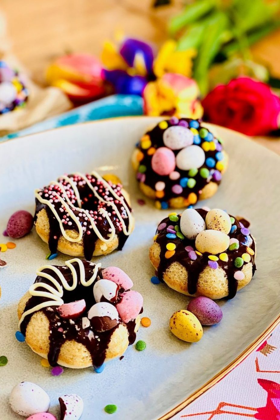 Easter baked doughnuts. Easter egg nests with a difference. Decorated with chocolate ganache, sprinkles and mini eggs
