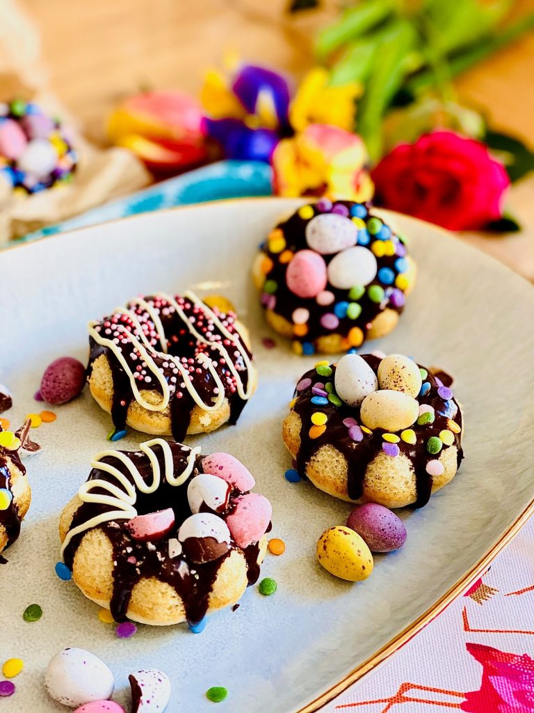 Easter baked doughnuts. Easter egg nests with a difference. Decorated with chocolate ganache, sprinkles and mini eggs