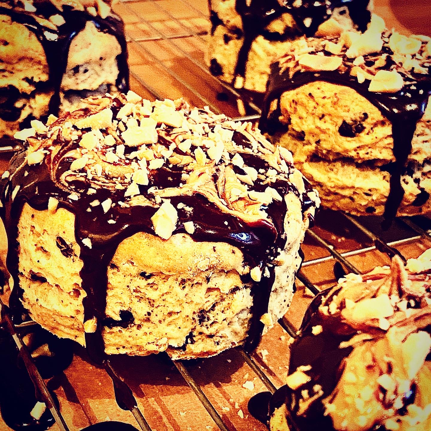 Vegan peanut butter and chocolate scones, topped with chocolate ganache icing and swirls of peanut butter with a crunchy peanut topping